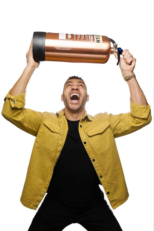 cheerful male holing fire extinguisher above his head